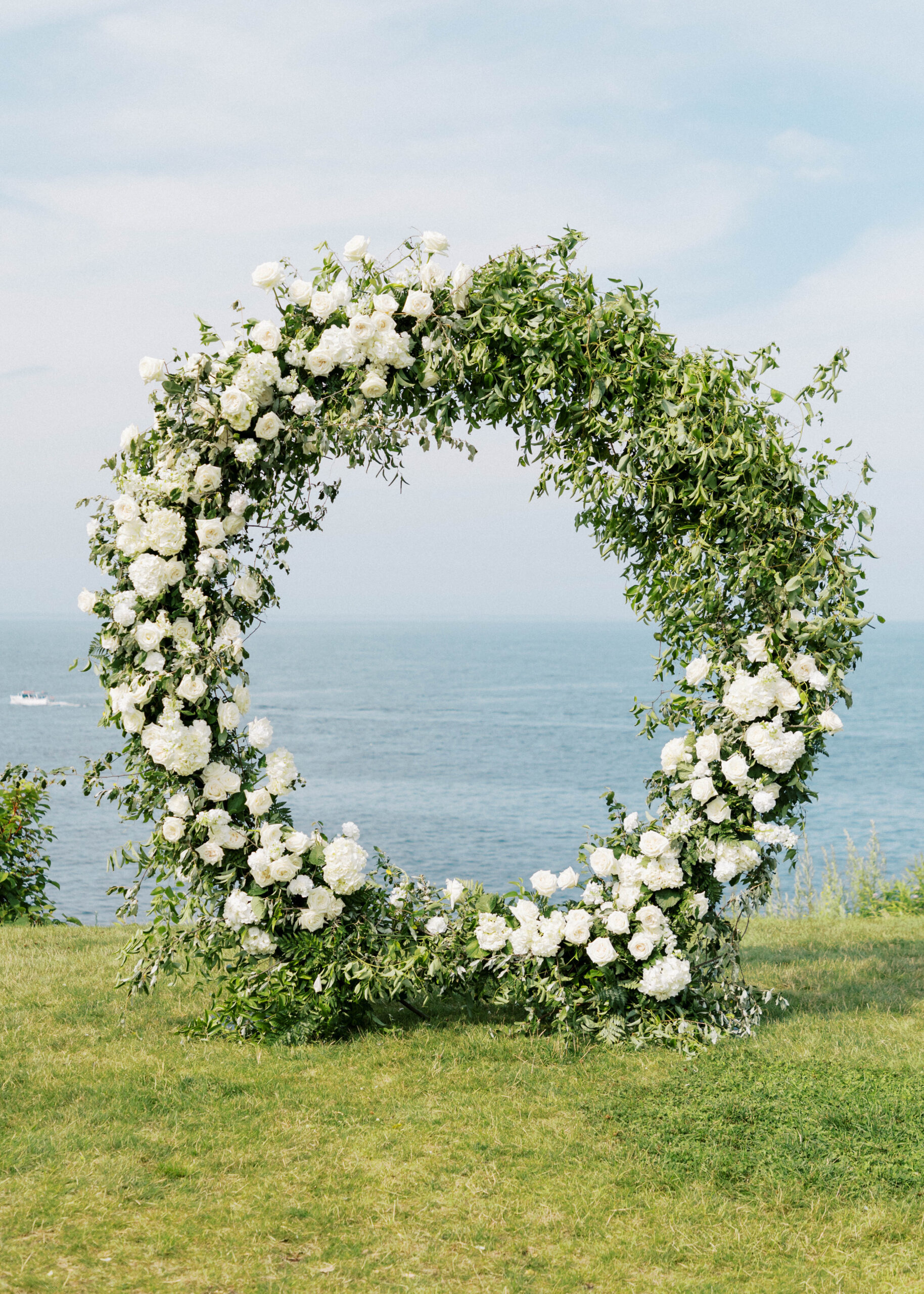 Beautiful wedding arch overlooking the Atlantic ocean made by a professional wedding florist