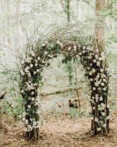 Classic Wedding floral arch in rustic rural setting