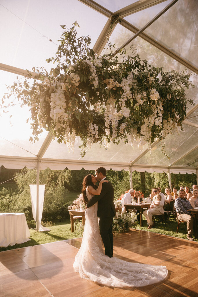 Gorgeous elevated floral chandelier above dancing newlyweds