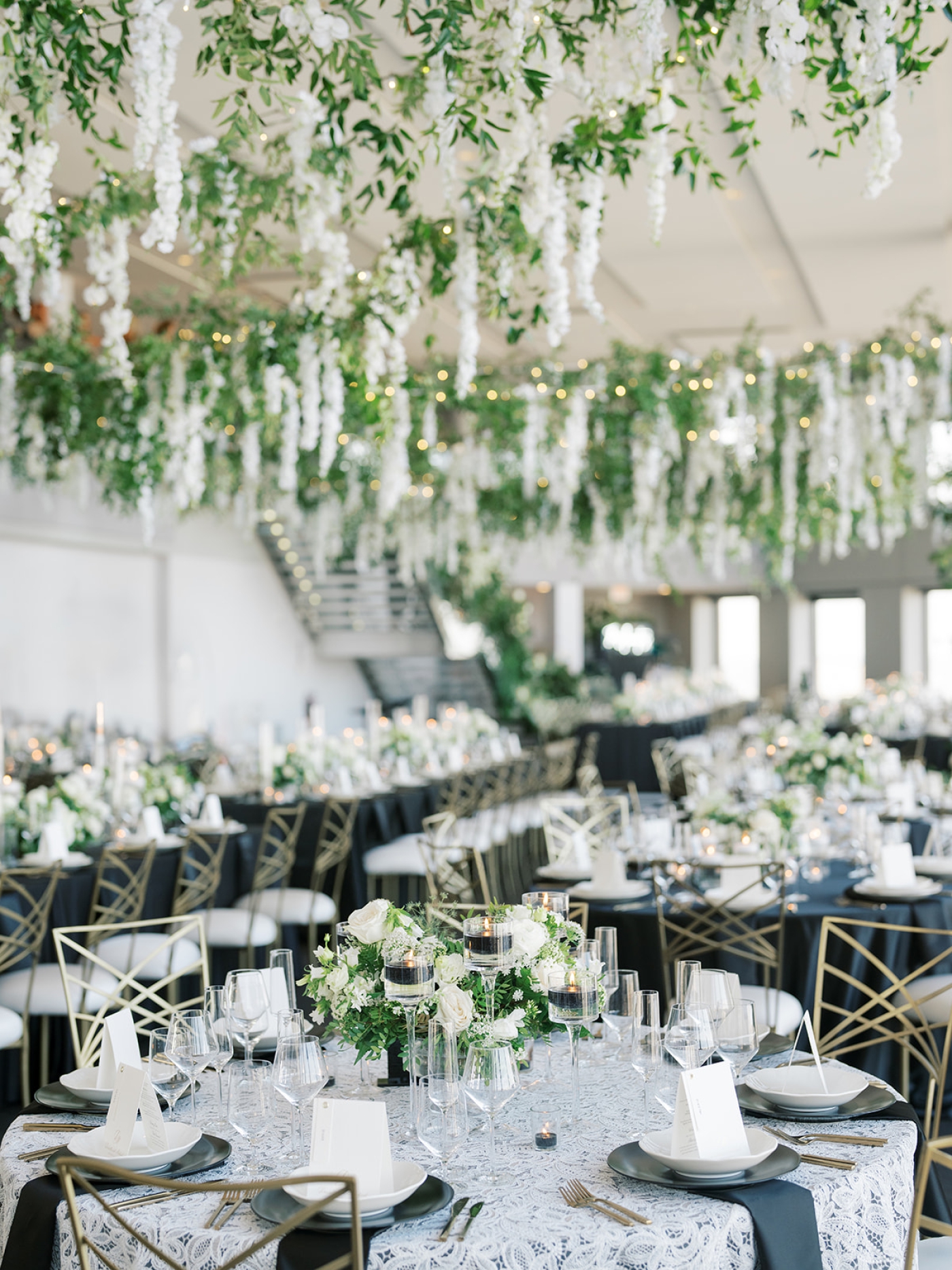Hanging wisteria over wedding reception tables at The State Room in Boston