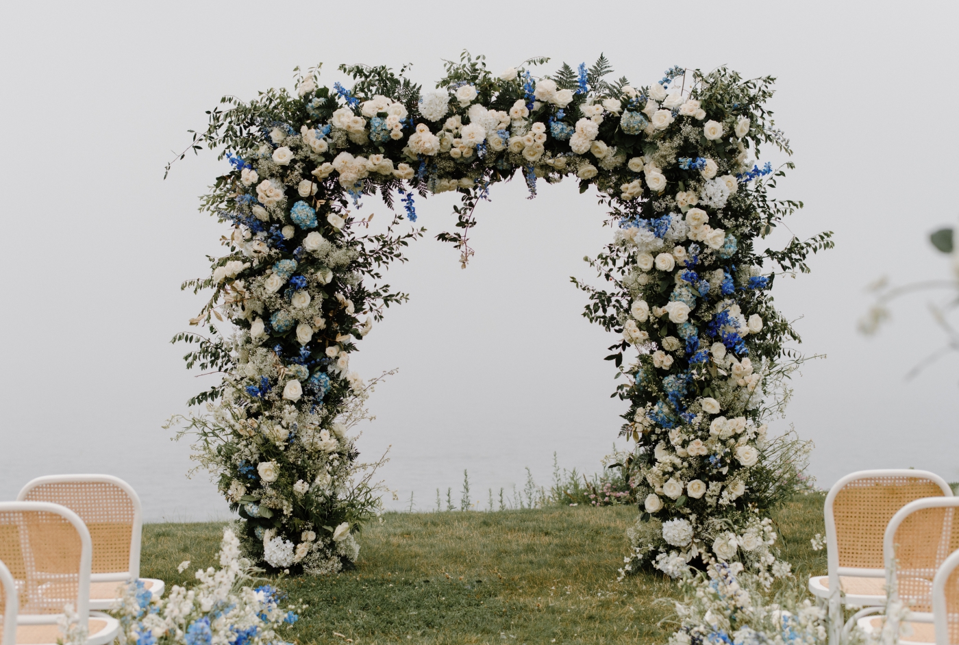 A foam-free wedding ceremony arbor covered with blue hydrangeas 