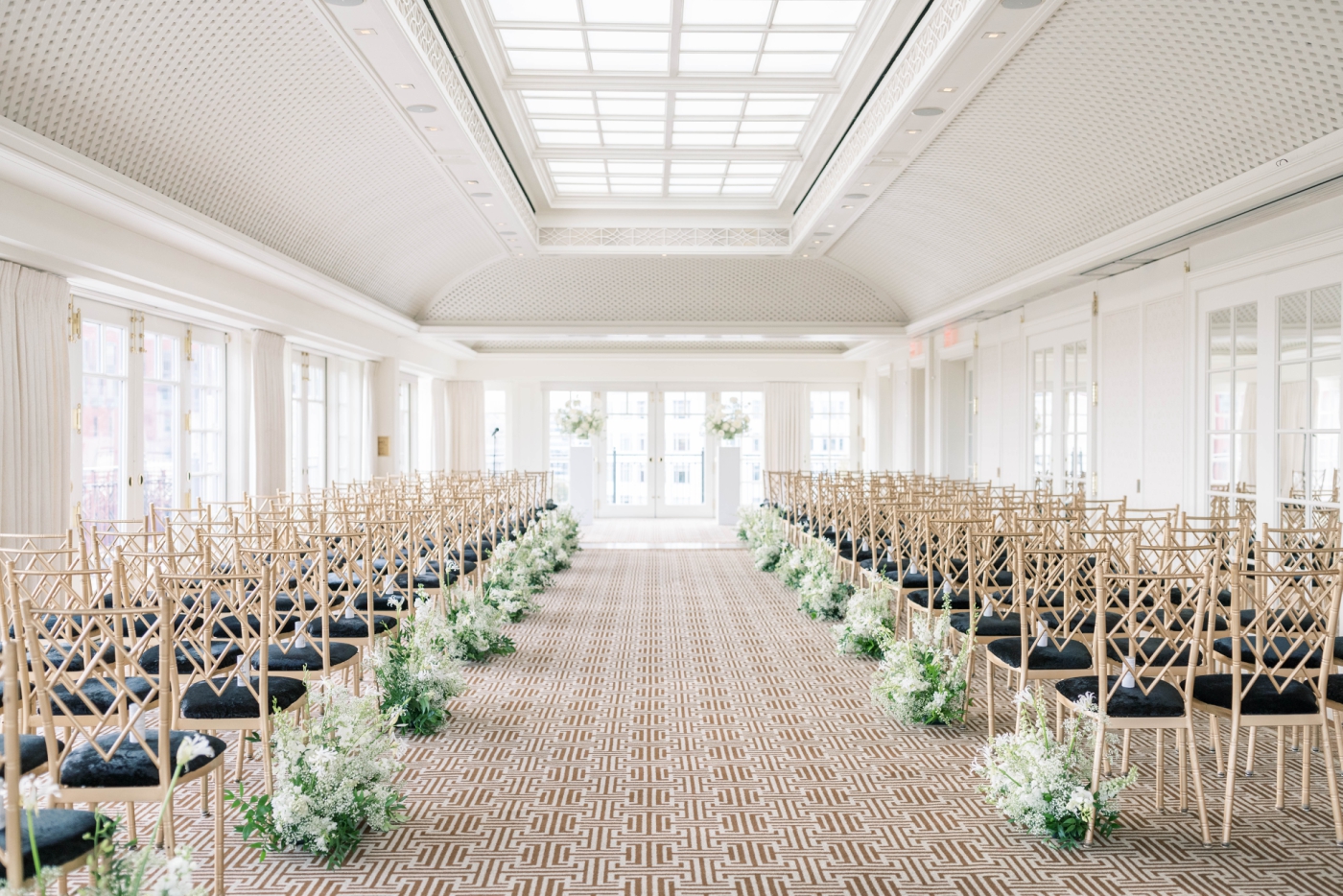 A well-lit ballroom in the Hay-Adams Hotel set up for a wedding ceremony