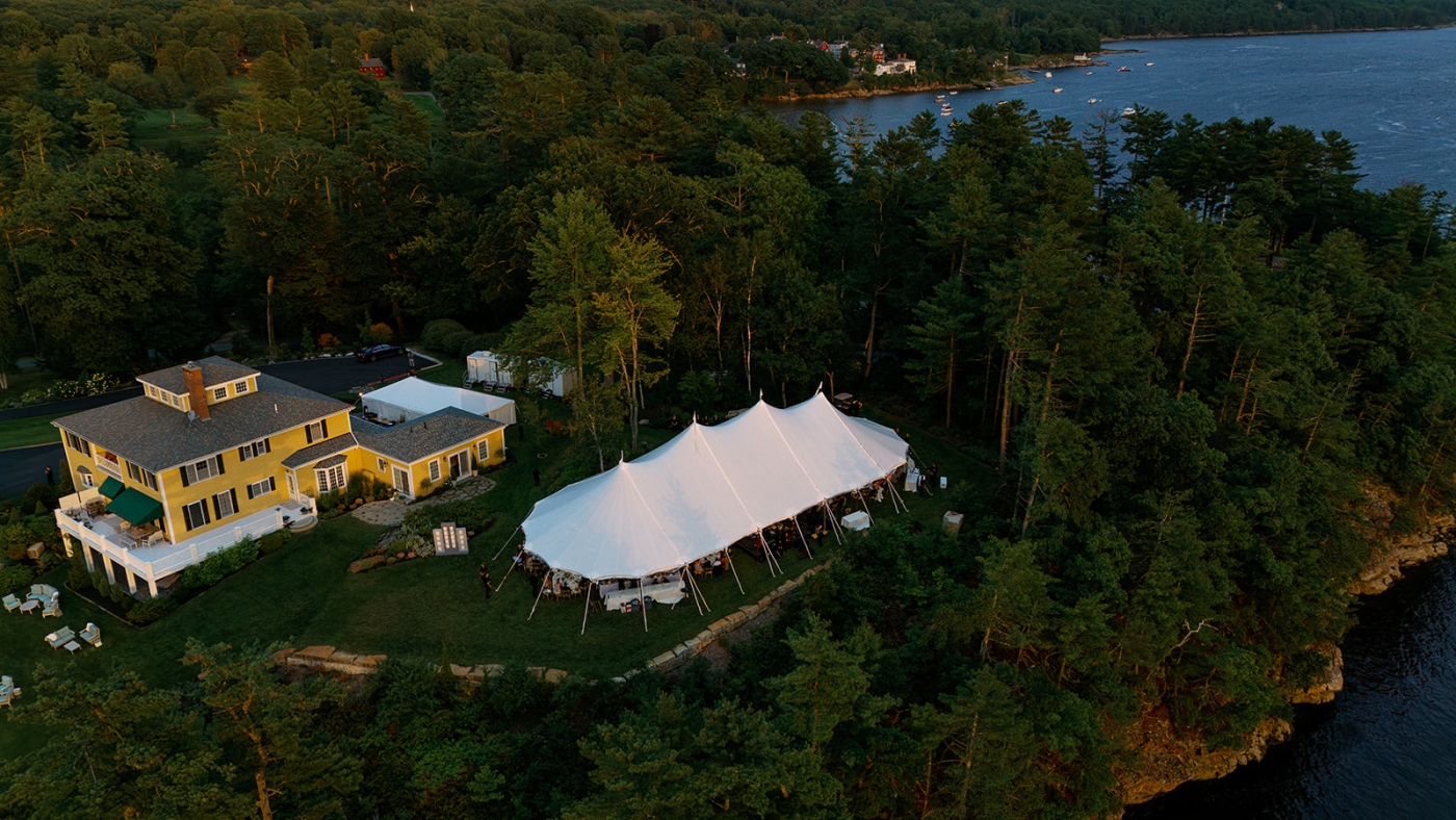 A drone photo of a private estate wedding on the Kennebec River