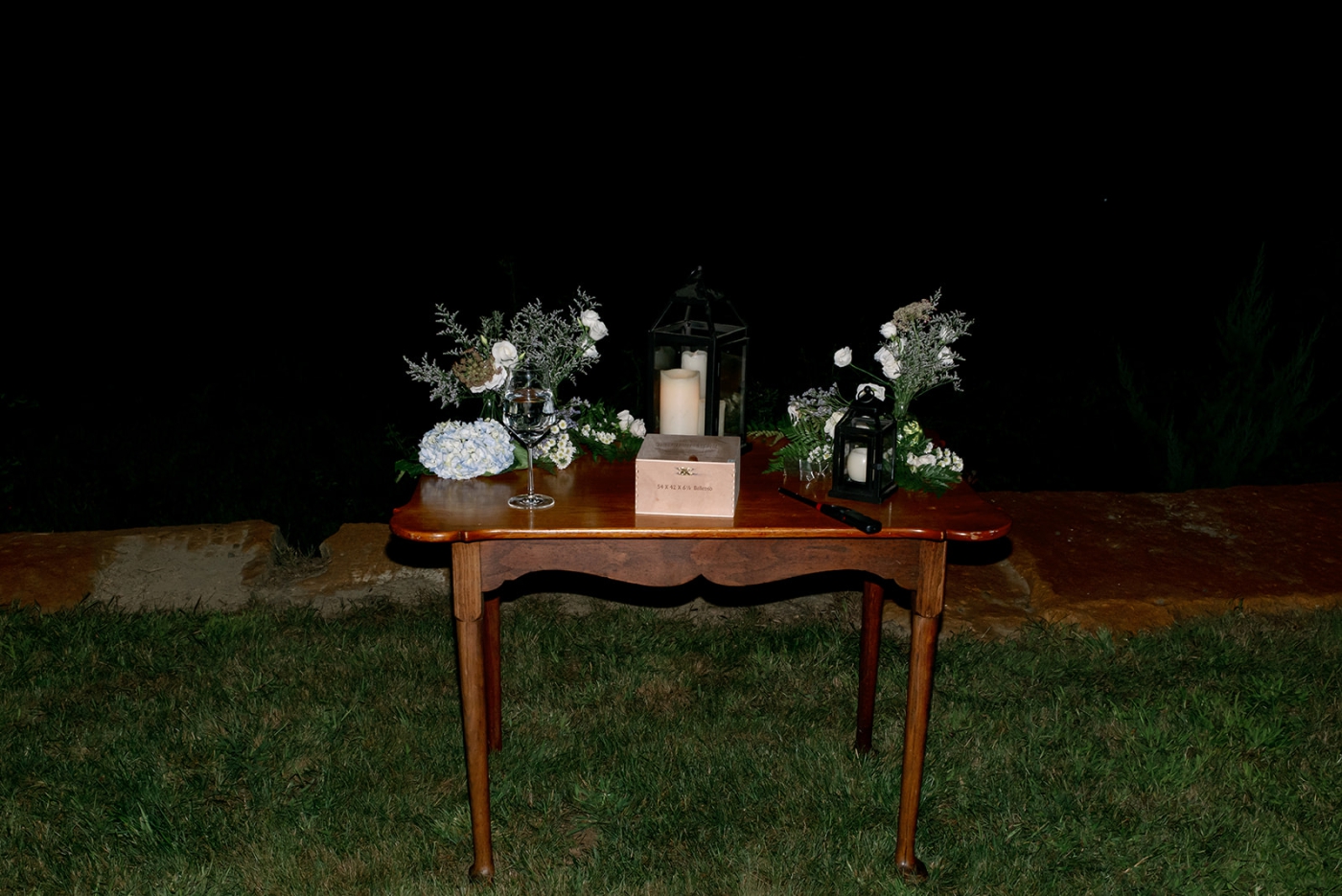 A wooden table for a guest book with flowers