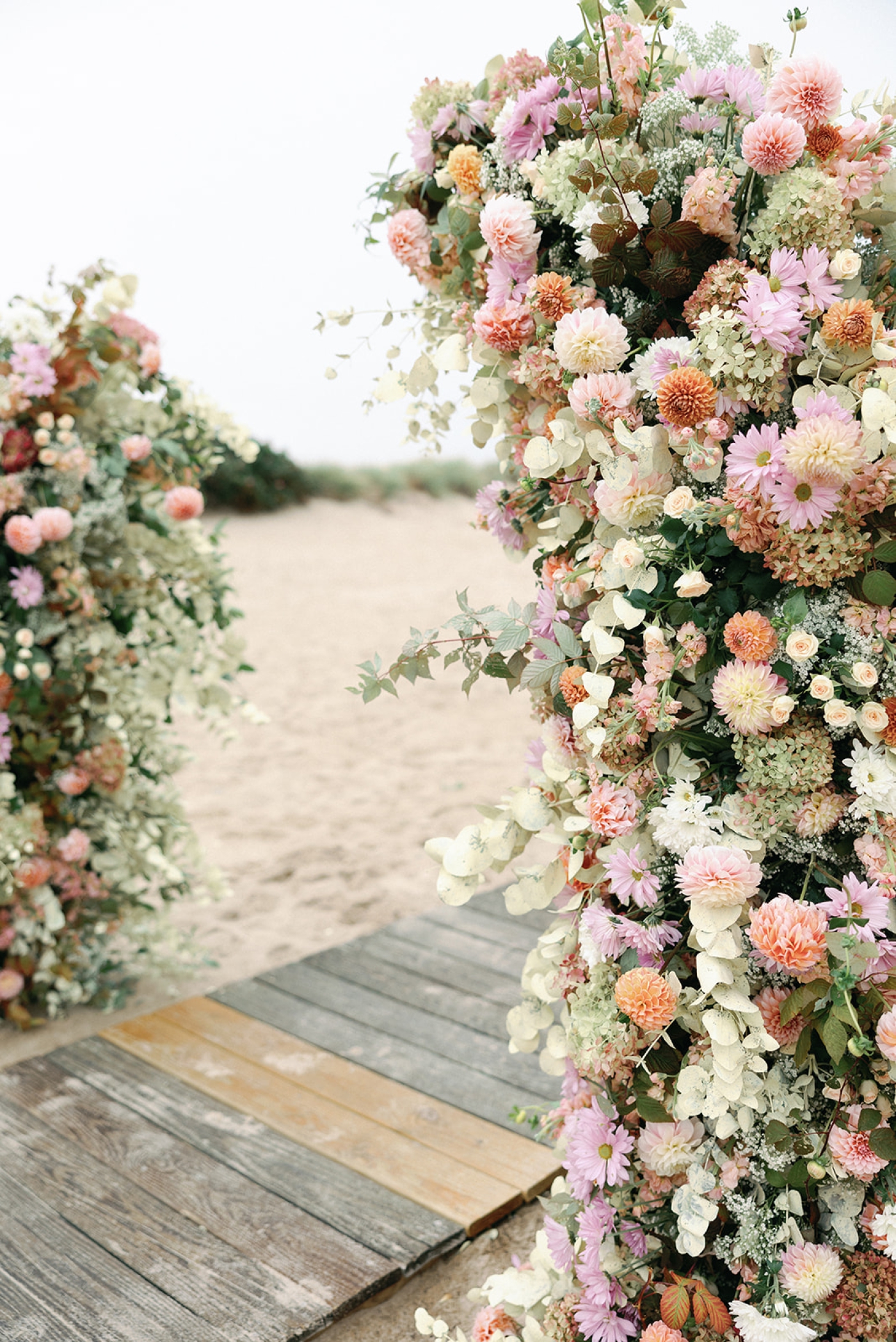 A half-arch floral altar piece for a beach wedding at Kalmar Village