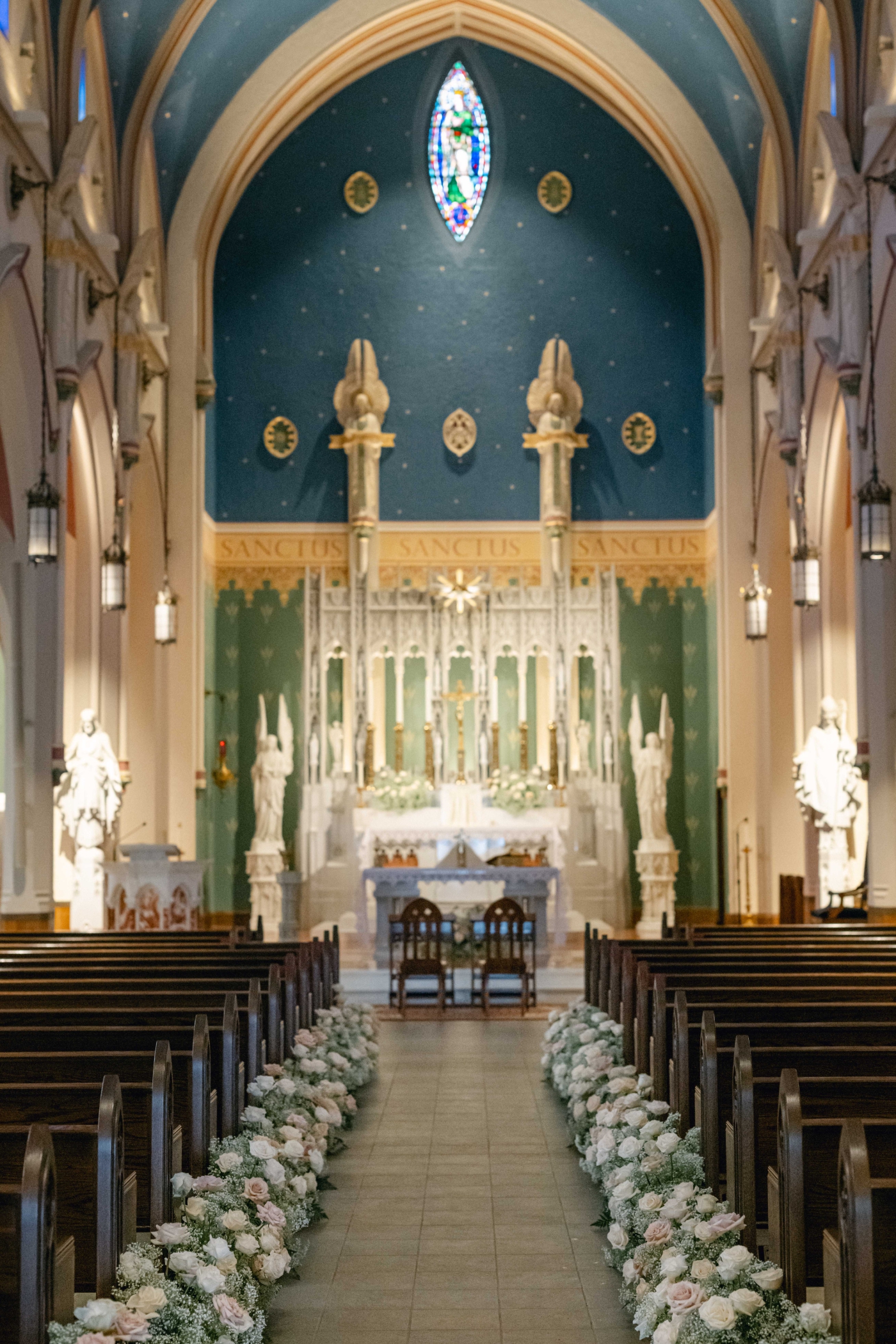 A catholic church in Portsmouth, New Hampshire, lined with 36 white and cream floral arrangements