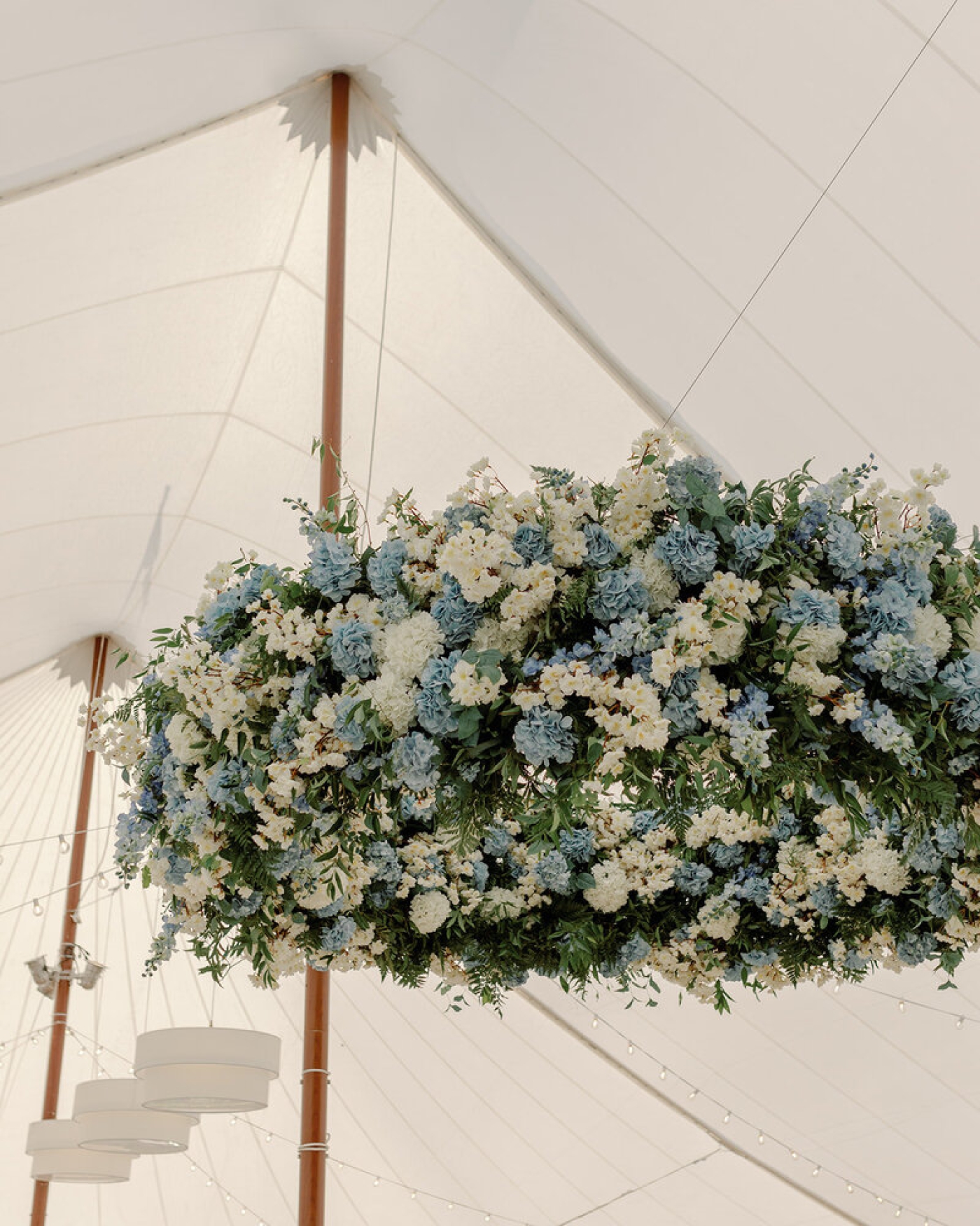 A hanging floral chandelier made of faux white and blue flowers