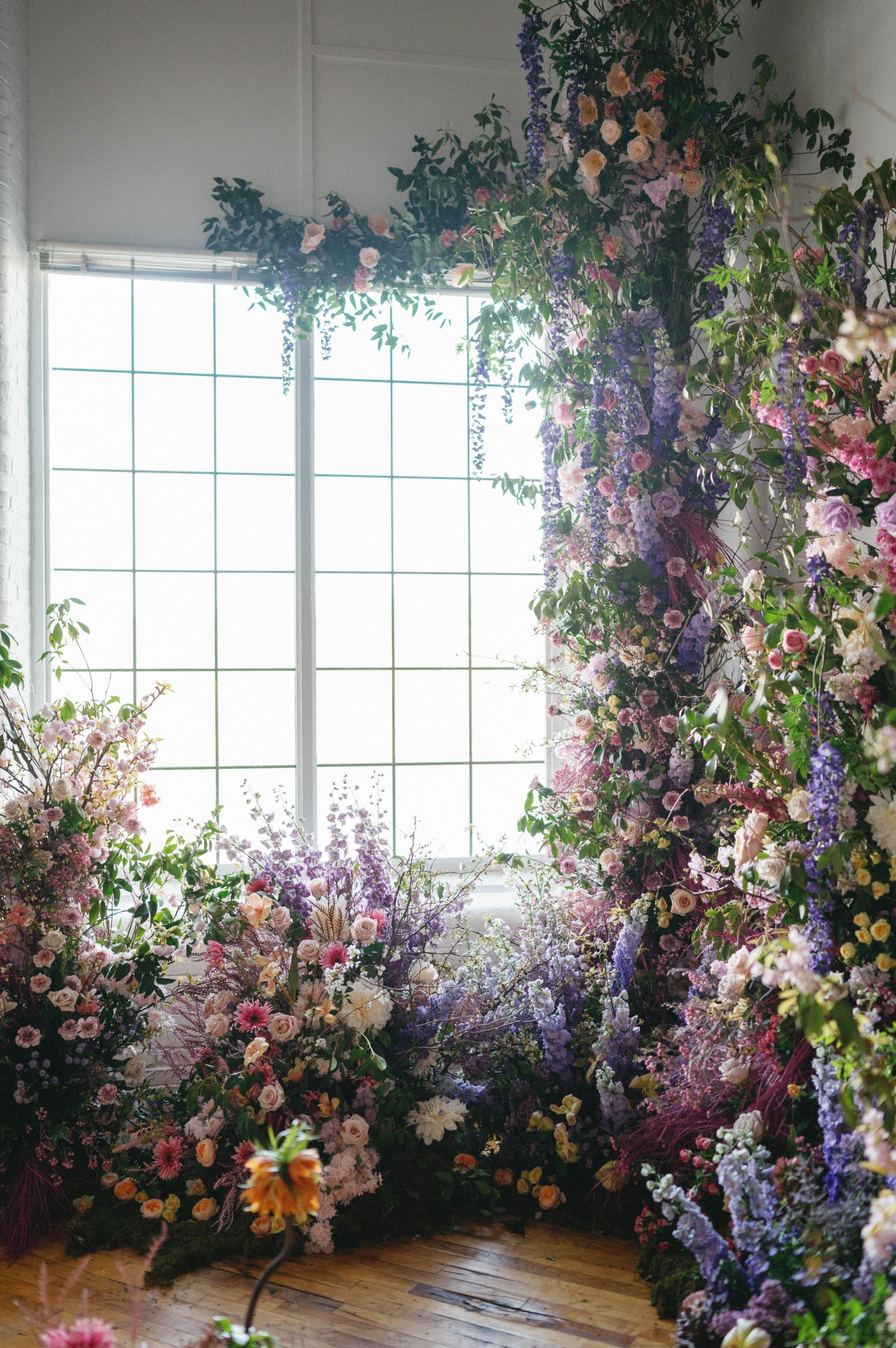 An organic-looking floral installation climbing up a wall and around a window