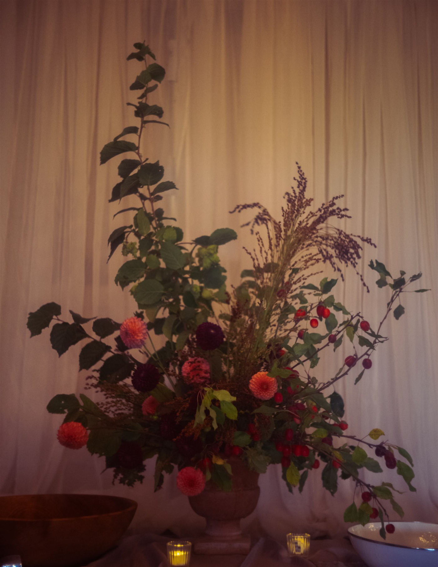 A bold, avant-garde floral arrangement at the entrance to a wedding reception at Megunticook Golf Club