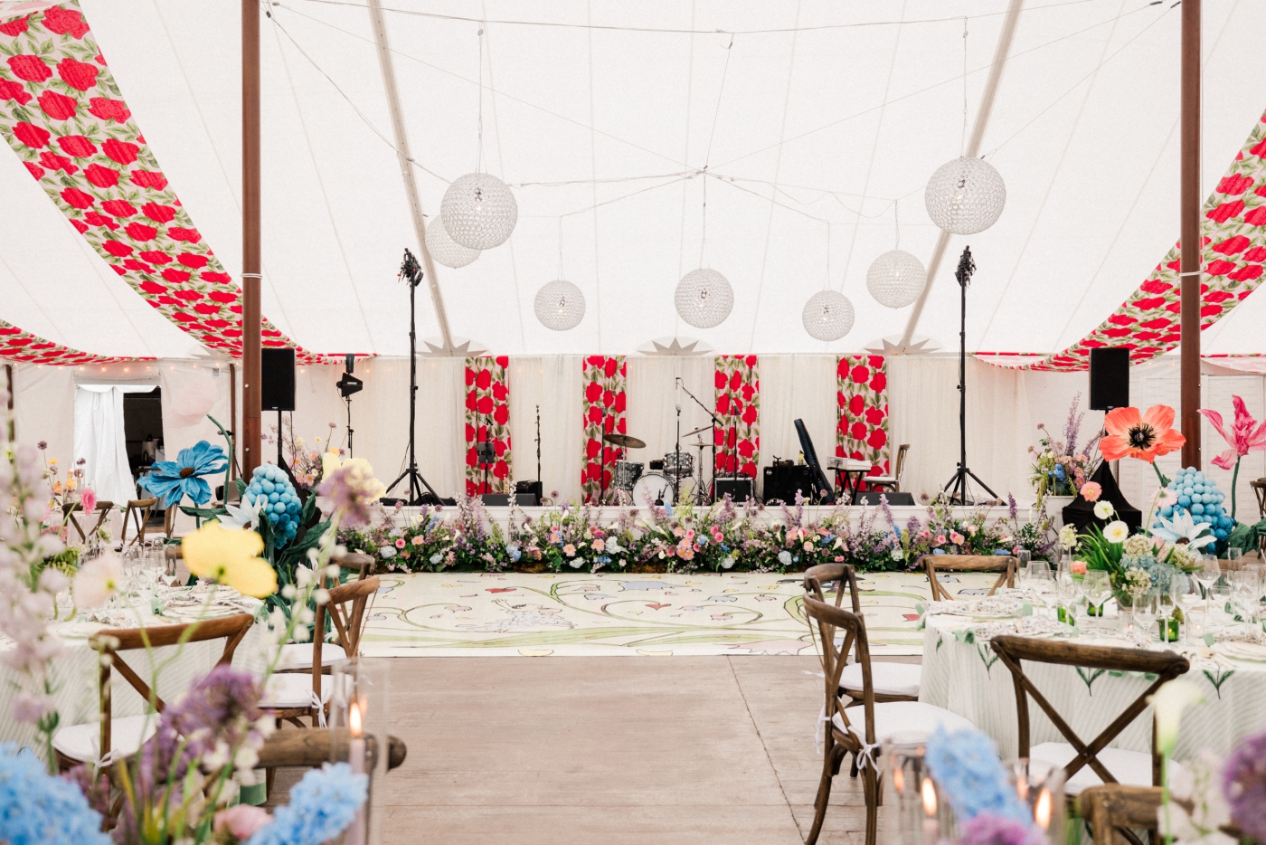 A large tent with custom red patterned draping