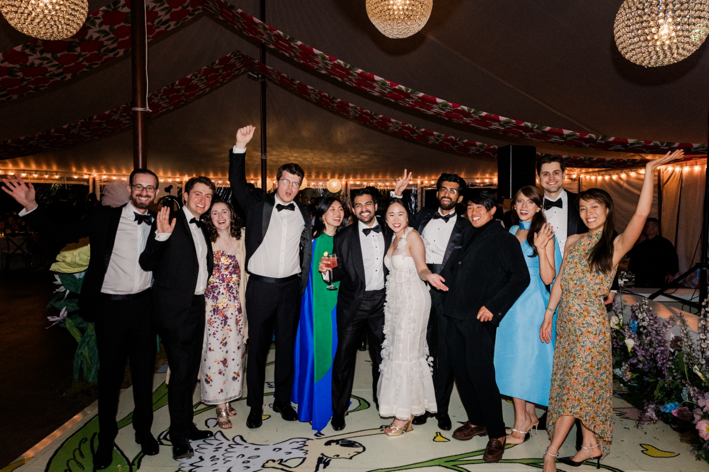 A bride and groom cheer with their friends